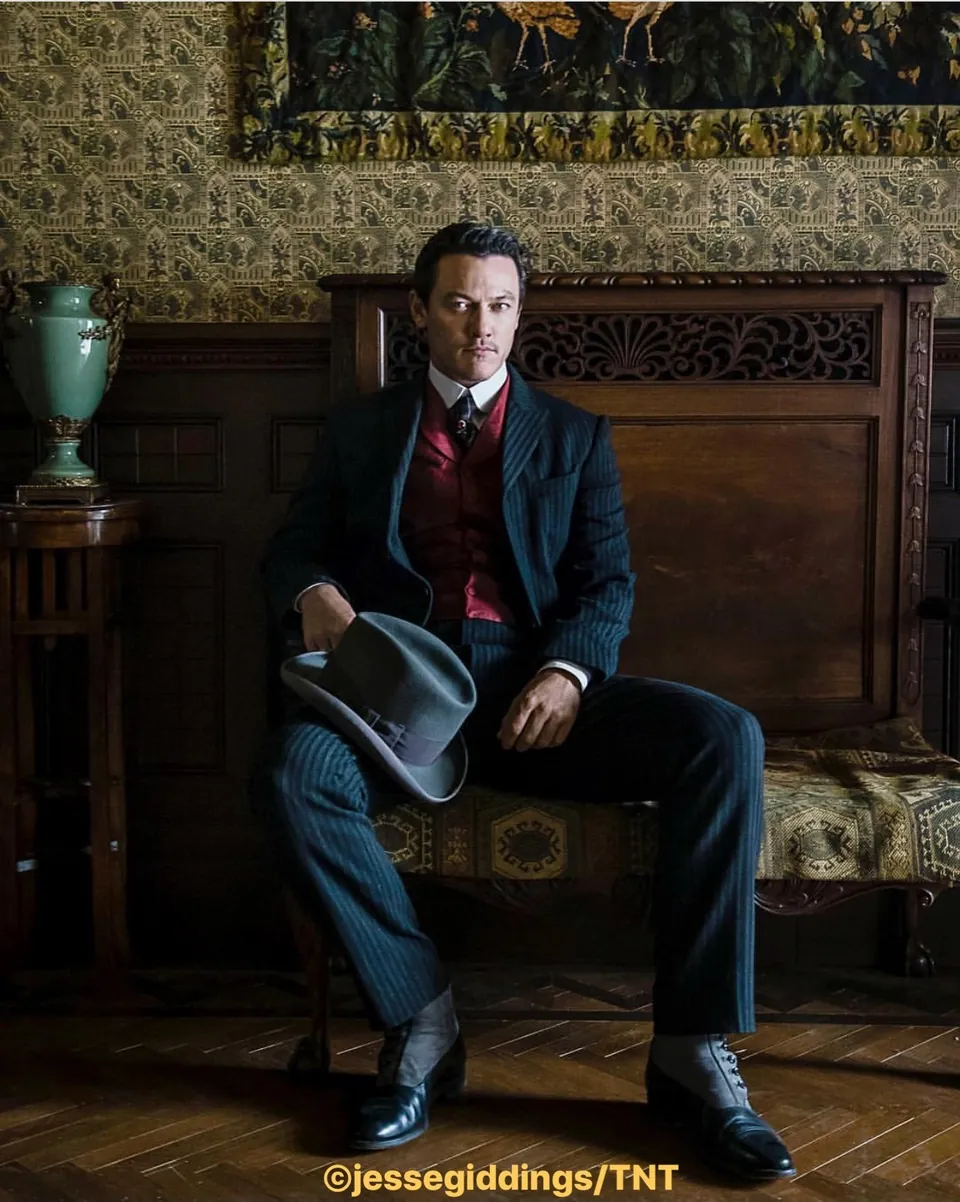 The Alienist social post: Luke Evans seated in period costume, credited @jessegiddings/TNT