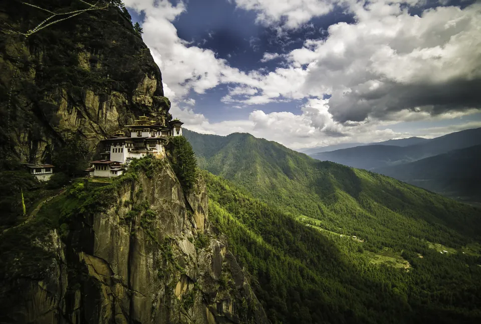 The Tiger's Nest monastery on a cliff above a green valley in Bhutan
